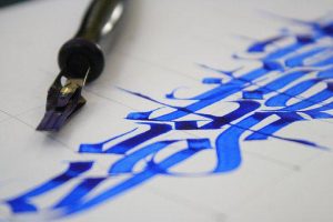 calligraphy example of blue letters on paper