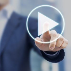 business man pressing video play button